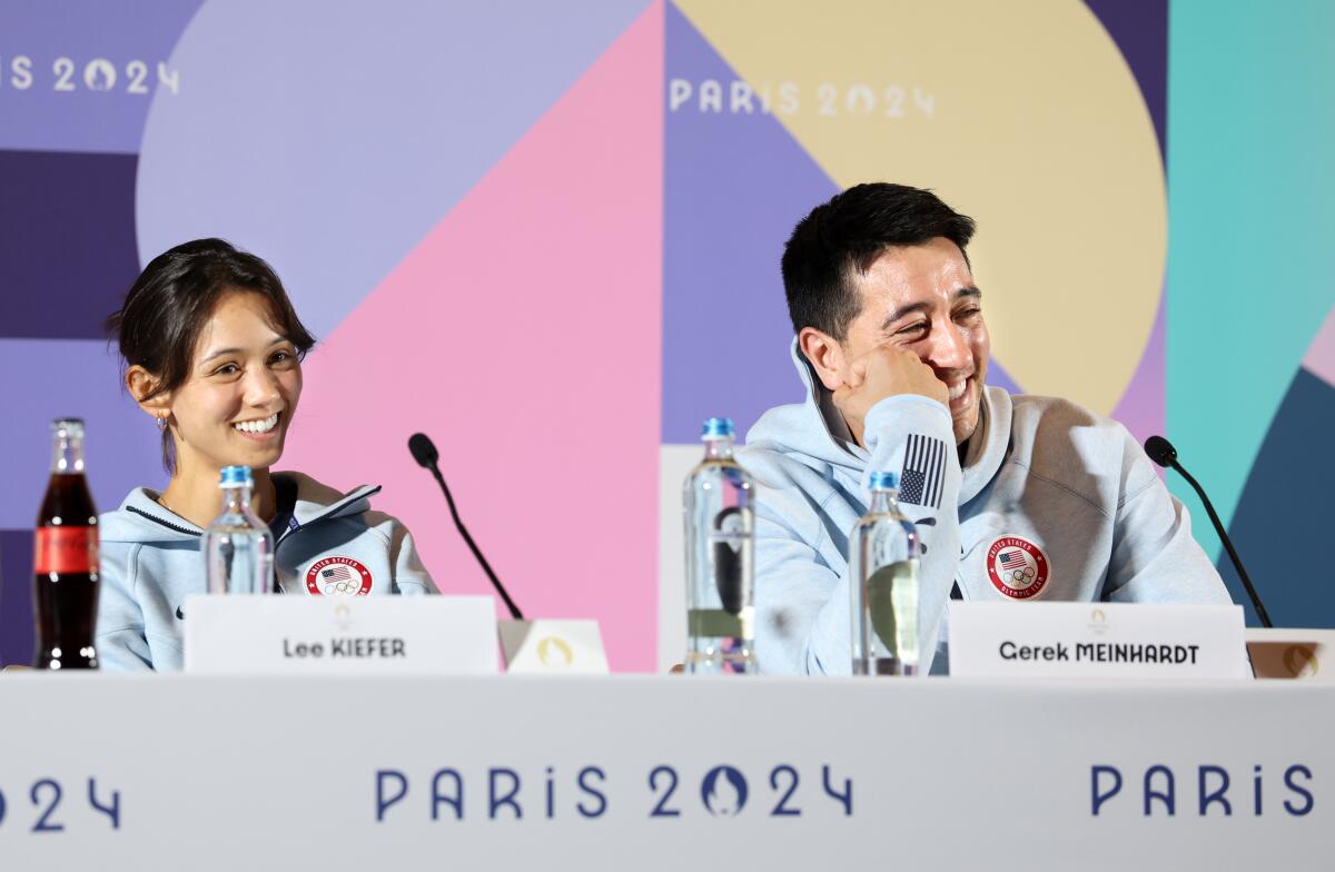 American fencers Lee Kiefer and Gerek Meinhardt answer questions during a news conference in Paris.