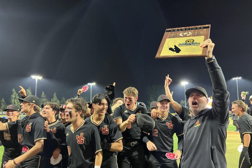 JSerra coach Brett Kay and his players celebrate a second straight Division 1 baseball title with a 1-0, eight-inning win. 