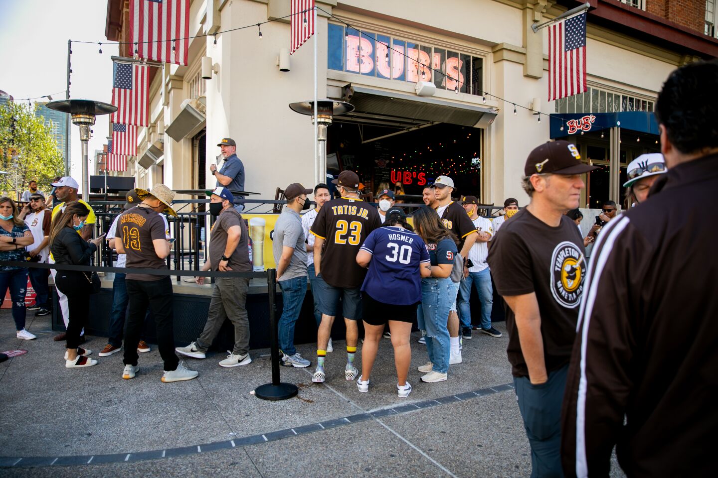 Fans wait in line outside Bub's by the Ballpark before the start of the Opening Day game between the San Diego Padres and the Arizona Diamondbacks in Downtown San Diego near Petco Park on Thursday, April 1, 2021 in San Diego, CA. The San Diego Padres welcomed a limited number of fans back into the stadium on Thursday for the first time since the beginning of the coronavirus pandemic.