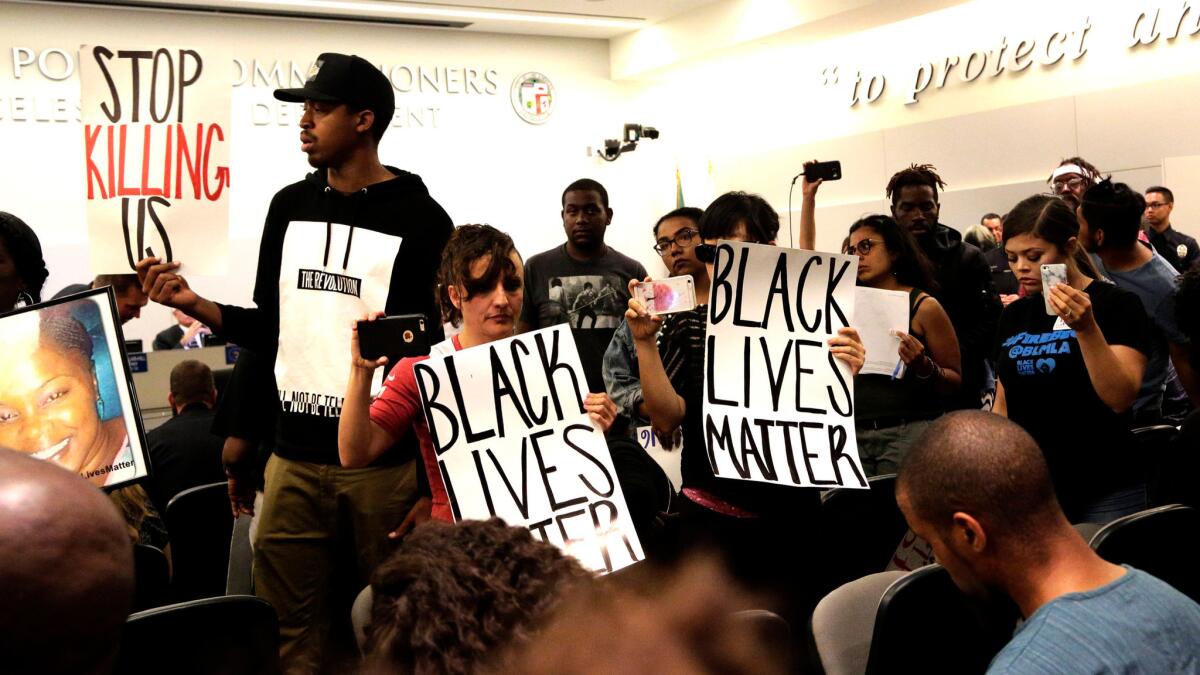 Black Lives Matter protesters demonstrate inside the LAPD Commission meeting in Los Angeles on Oct. 4.