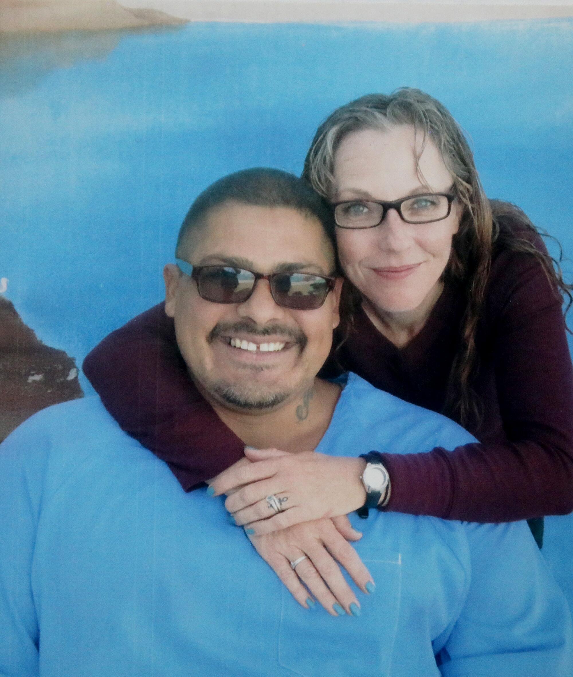 A man and woman smile for a photo.