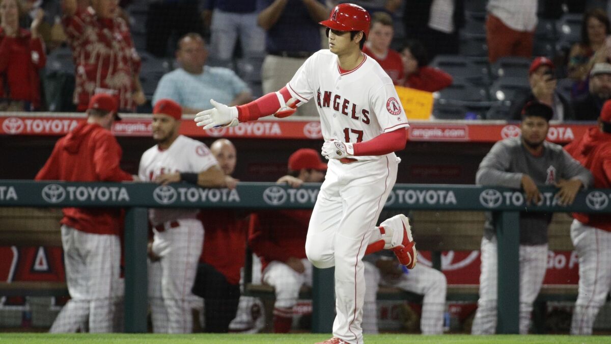 The Angels' Shohei Ohtani celebrates after his first-inning home run against the Texas Rangers on Monday.