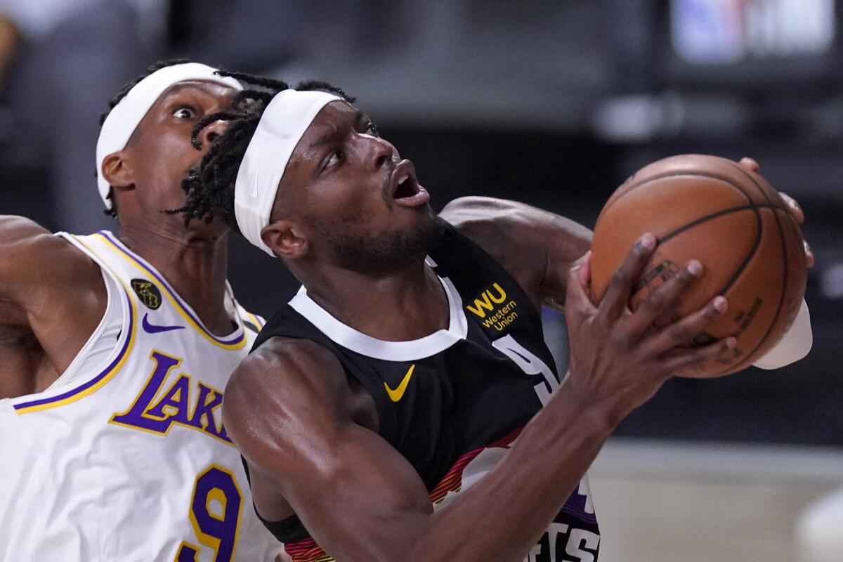  Nuggets forward Jerami Grant drives for a layup against Lakers guard Rajon Rondo during the second half of Game 3.