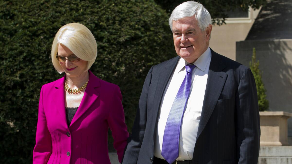 Former House Speaker Newt Gingrich and his wife Callista leave a closed-door meeting with Republican presidential candidate Donald Trump in Washington on March 21.