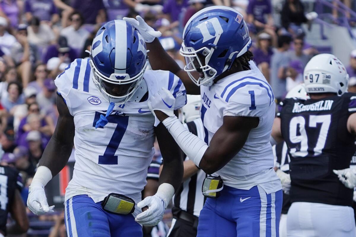 Duke running back Jordan Waters (7) celebrates his touchdown against Northwestern with wide receiver Jontavis Robertson (1) during the first half of an NCAA college football game, Saturday, Sept.10, 2022, in Evanston, Ill. (AP Photo/David Banks)