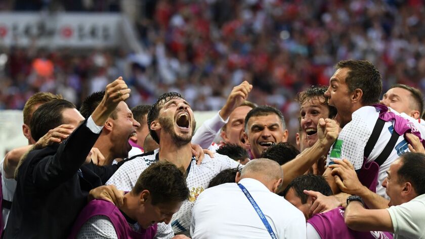Russia's players celebrate their victory at the end of the Russia 2018 World Cup round of 16 football match between Spain and Russia at the Luzhniki Stadium in Moscow on July 1, 2018.