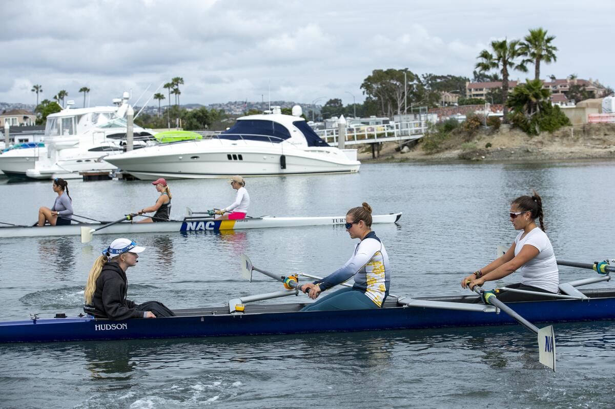 Coxswain Hannah Hykes, left, and Millie Clark, in the stroke seat, lead their team on a practice on Wednesday in Newport Bay.