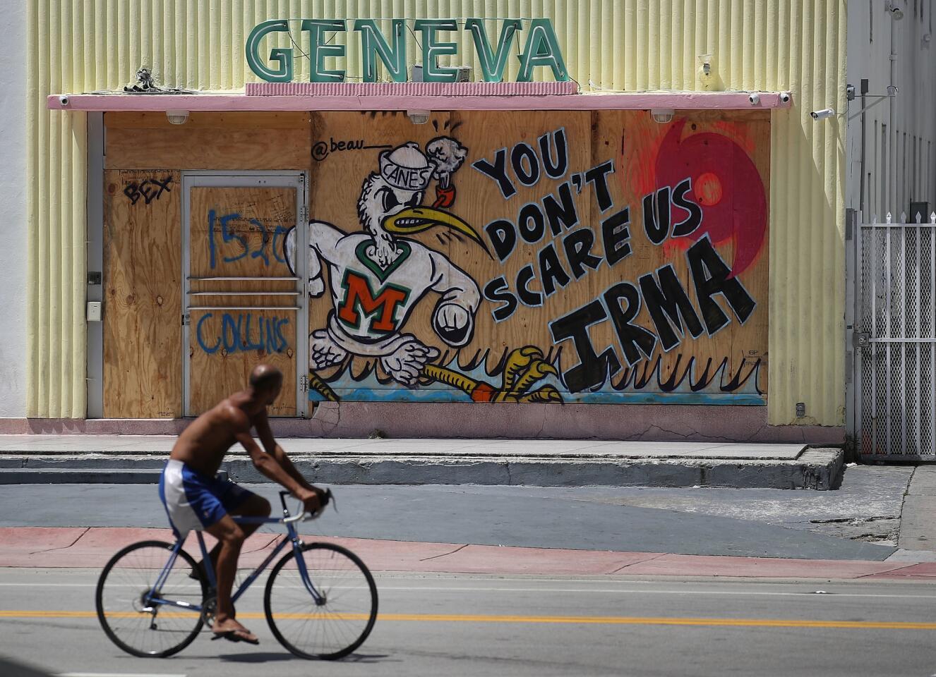 A message reading "You Don't Scare Us Irma" is written on plywood being used to cover the windows of a building as people prepare for the arrival of Hurricane Irma on Sept. 8, 2017 in Miami Beach, Fla.
