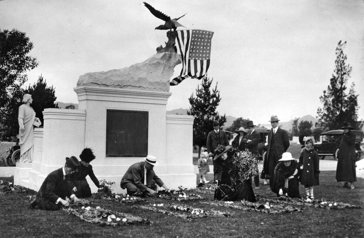 May 30, 1917: Friends and family of Los Angeles Times employees killed in the Oct. 1, 1910 bombing, spend Memorial Day decorating and cleaning plots at the Los Angeles Times Bombing Memorial at Hollywood Forever Cemetery.