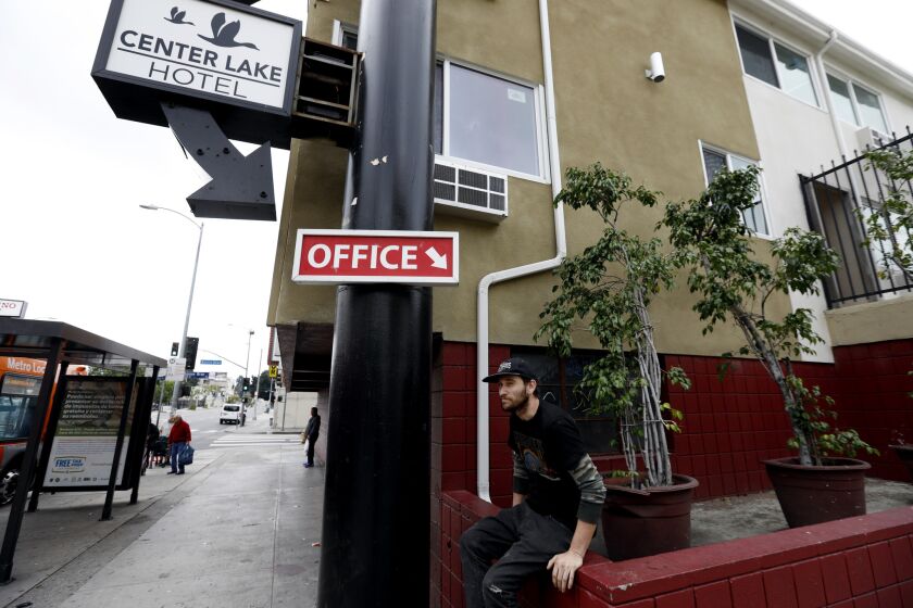 LOS ANGELES, CA MARCH 20, 2019: Peter Nelson waits for the bus infront of the closed Center Lake Hotel in Los Angeles, CA March 20, 2019. The case of the Royal Park Motel  now known as West Third Apartments  has alarmed legal advocates who argue that the city has undermined the purpose and violated its own rules for Prop. HHH, a $1.2 billion bond approved by voters for homeless housing. Under HHH regulations, money cannot be awarded to buy or rehabilitate a residential building that is already occupied, attorneys pointed out. (Francine Orr/ Los Angeles Times)