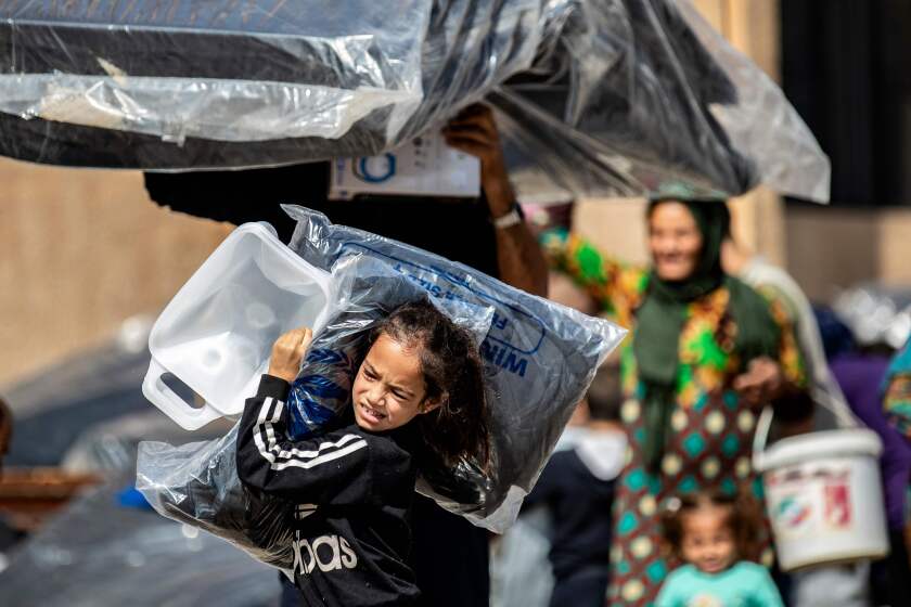 Syrian refugees receive humanitarian aid in Tal Tamr in Hasakeh province.