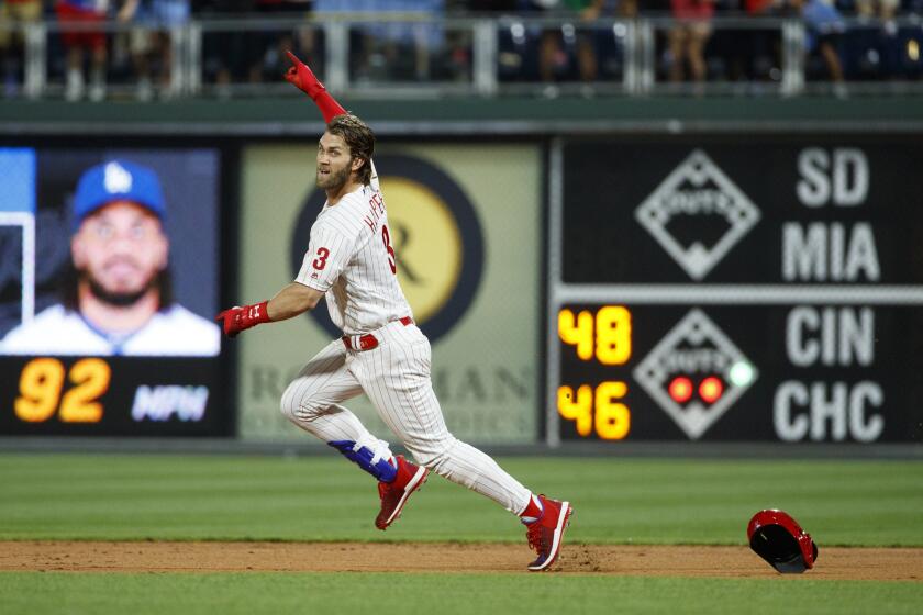 Philadelphia Phillies' Bryce Harper celebrates after hitting a game-winning two-run double off Dodgers relief pitcher Kenley Jansen.