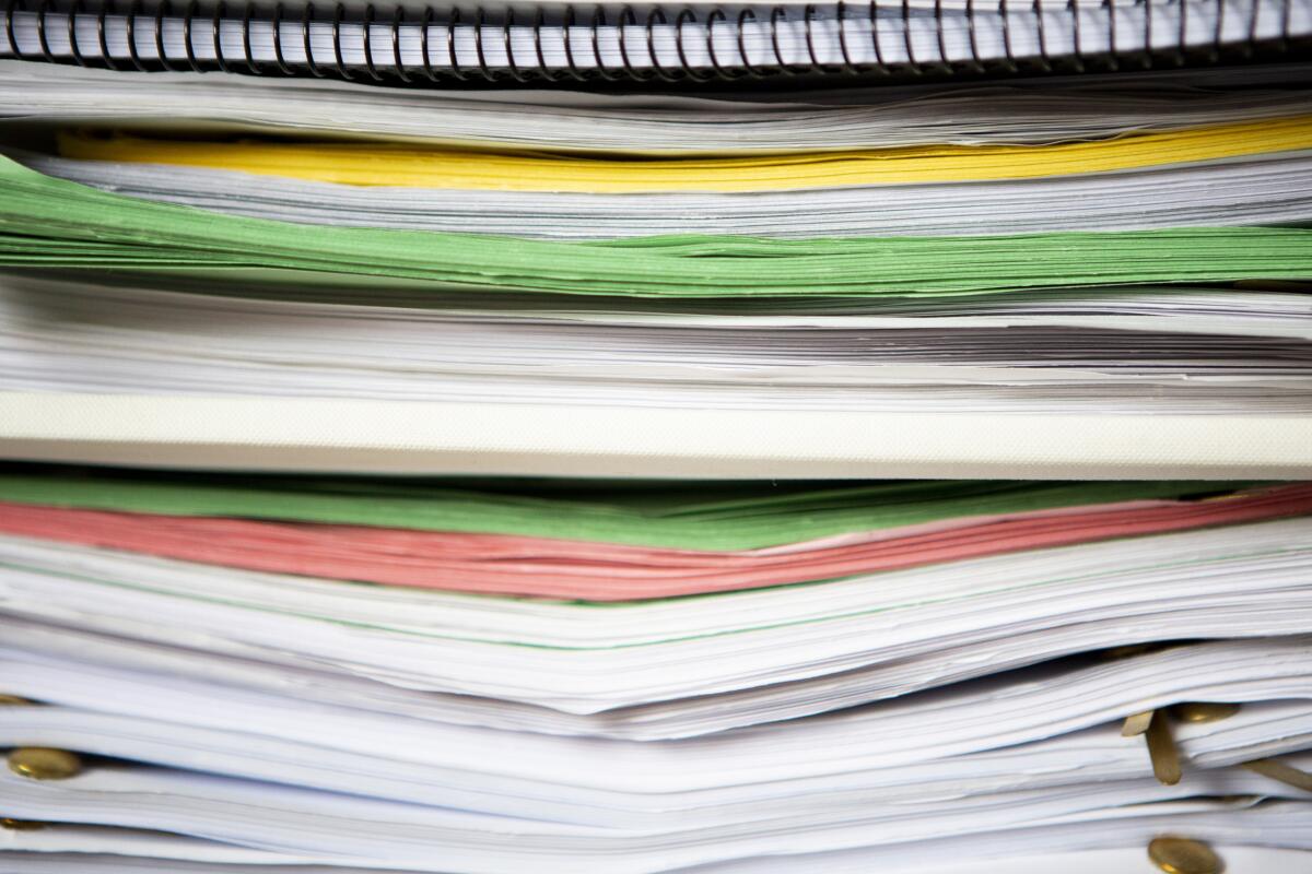 A stack of scripts sits on actor Brendan Meyer's bookshelf.