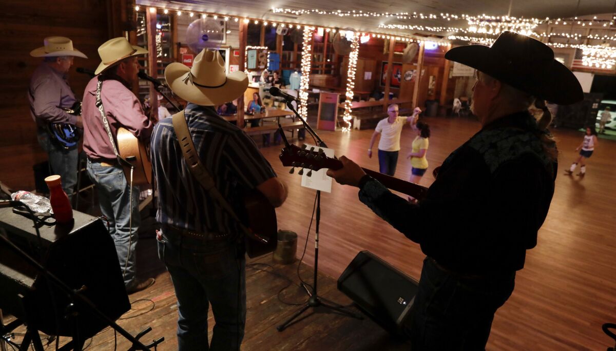 The Caliche Crossroads country band plays at Twin Sisters Dance Hall in Blanco, Texas. (Katie Falkenberg / Los Angeles Times)
