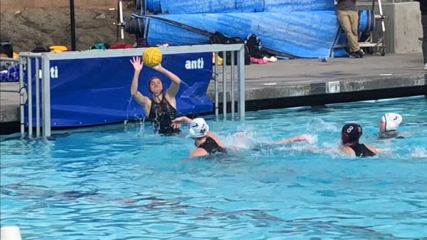 Rylie Hage makes a save in goal for the Point Loma High girls water polo team.