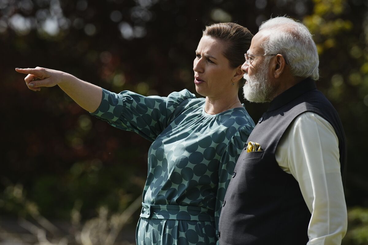Danish Prime Minister Mette Frederiksen, left, and Indian Prime Minister Narendra Modi, talk in the garden of the prime minister's official residence Marienborg, in Kongens Lyngby, north of Copenhagen, Denmark, Tuesday, May 3, 2022. Modi is on a two-day visit to Denmark. (Martin Sylvest/Ritzau Scanpix via AP)