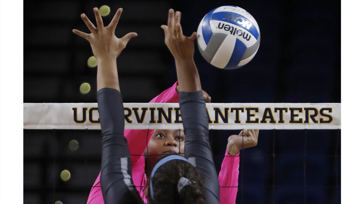 Idara Akpakpa spikes the ball against Cal State Fullerton at UCI's Bren Events Center.