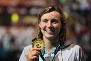 Gold medalist Katie Ledecky of the United States poses with her medal after the Women 800m Freestyle.