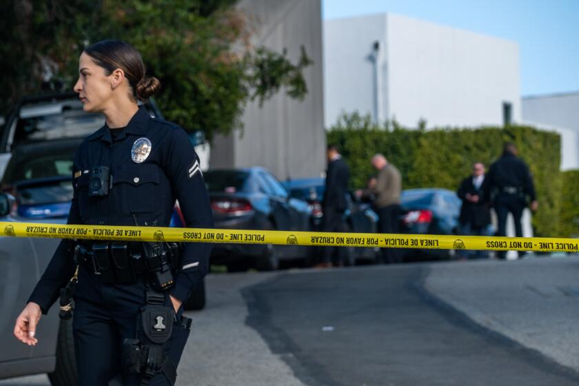 Beverly Hills, CA - January 28: LAPD officer Prescott stands on the 2700 block of Ellison Drive on Saturday, Jan. 28, 2023, in Beverly Hills, CA. The street is blocked off due to a police investigation. Police are investigating a shooting that occurred today in the Beverly Crest area of Los Angeles, bordering Beverly Hills, where allegedly three people were killed and four others were critically wounded. The initial dispatch was an ``assault with a deadly weapon call" in the 2700 block of Ellison Drive about 2:40 a.m., the Los Angeles Police Department's Media Relations Division reported. (Francine Orr / Los Angeles Times)