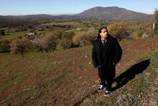 SQUAW VALLEY, CA - JANUARY 11: Roman C. Rain Tree, 40, of Fresno, founder of Rename S-Valley Coalition, an Indigenous group, is a member of the Dunlap Band of Mono Indians and Choi Numni people, overlooking Squaw Valley on Tuesday, Jan. 11, 2022 in Squaw Valley, CA. Rename S-Valley Coalition, an Indigenous group, takes fight to rename town of Squaw Valley, a town of about 3,600 people, to the Board on Geographic Names, a federal body tasked with naming geographic places. The coalition's founder, Roman C. Rain Tree, 40, of Fresno, said Fresno County leaders have ignored his proposal. (Gary Coronado / Los Angeles Times)