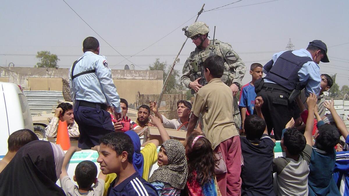 Then-Army Lt. Josh Mantz, center,  on a humanitarian patrol in Sadr City, Iraq, about an hour before he was wounded on April 21, 2007. Mantz’s response to trauma provides the foundation for his inspirational talks. 

