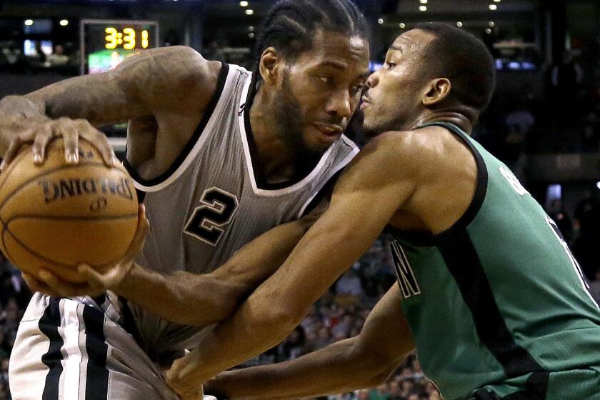 Spurs forward Kawhi Leonard looks to drive against Celtics guard Avery Bradley during the first half Friday night.