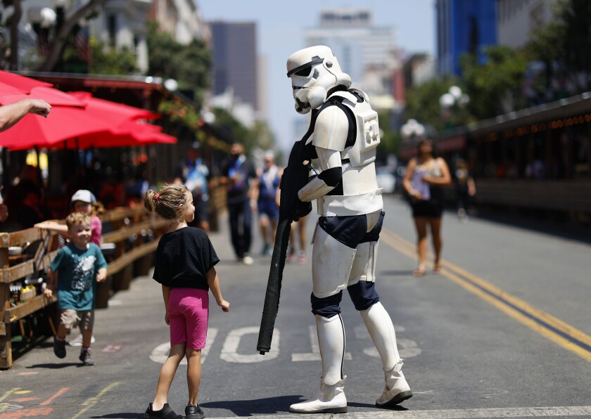 A person dressed as a stormtrooper walked down 5th Ave. near Comic-Con in San Diego on Sunday.