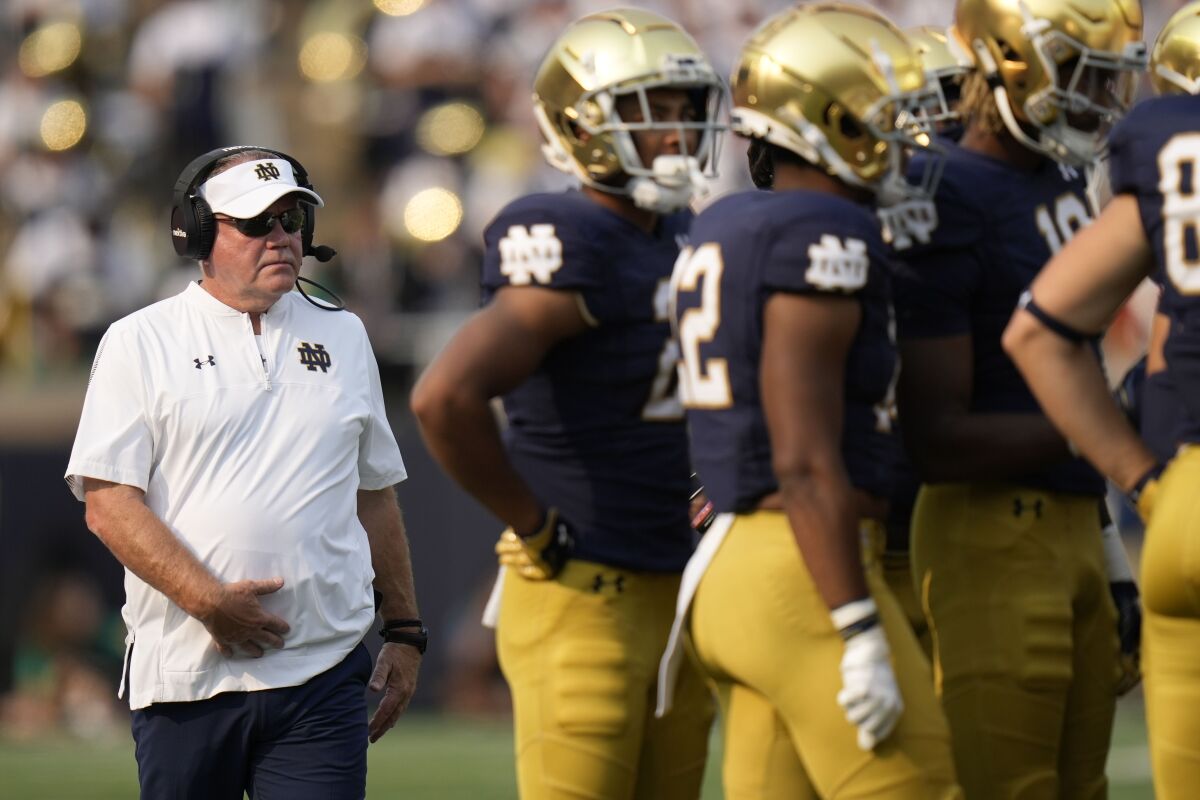Notre Dame head coach Brian Kelly walks to a huddle as his team plays Toledo in the second half of an NCAA college football game in South Bend, Ind., Saturday, Sept. 11, 2021. Notre Dame won 32-29. (AP Photo/AJ Mast)