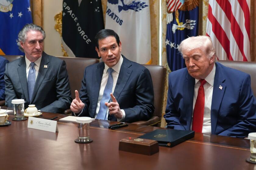 Secretary of State Marco Rubio, center, speaks during a Cabinet meeting at the White House as President Donald Trump and Interior Secretary Doug Burgum listen, Thursday, March 26, 2026, in Washington. (AP Photo/Alex Brandon)