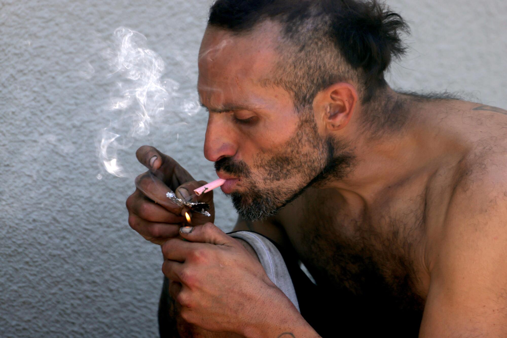 A man lights up in the MacArthur Park area of Los Angeles.