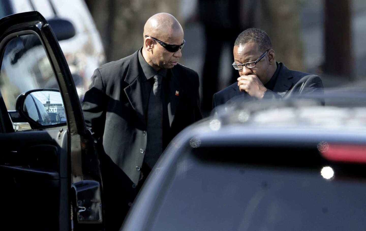 Singer Bobby Brown, right, gets into his car after leaving the funeral of his ex-wife, Whitney Houston.