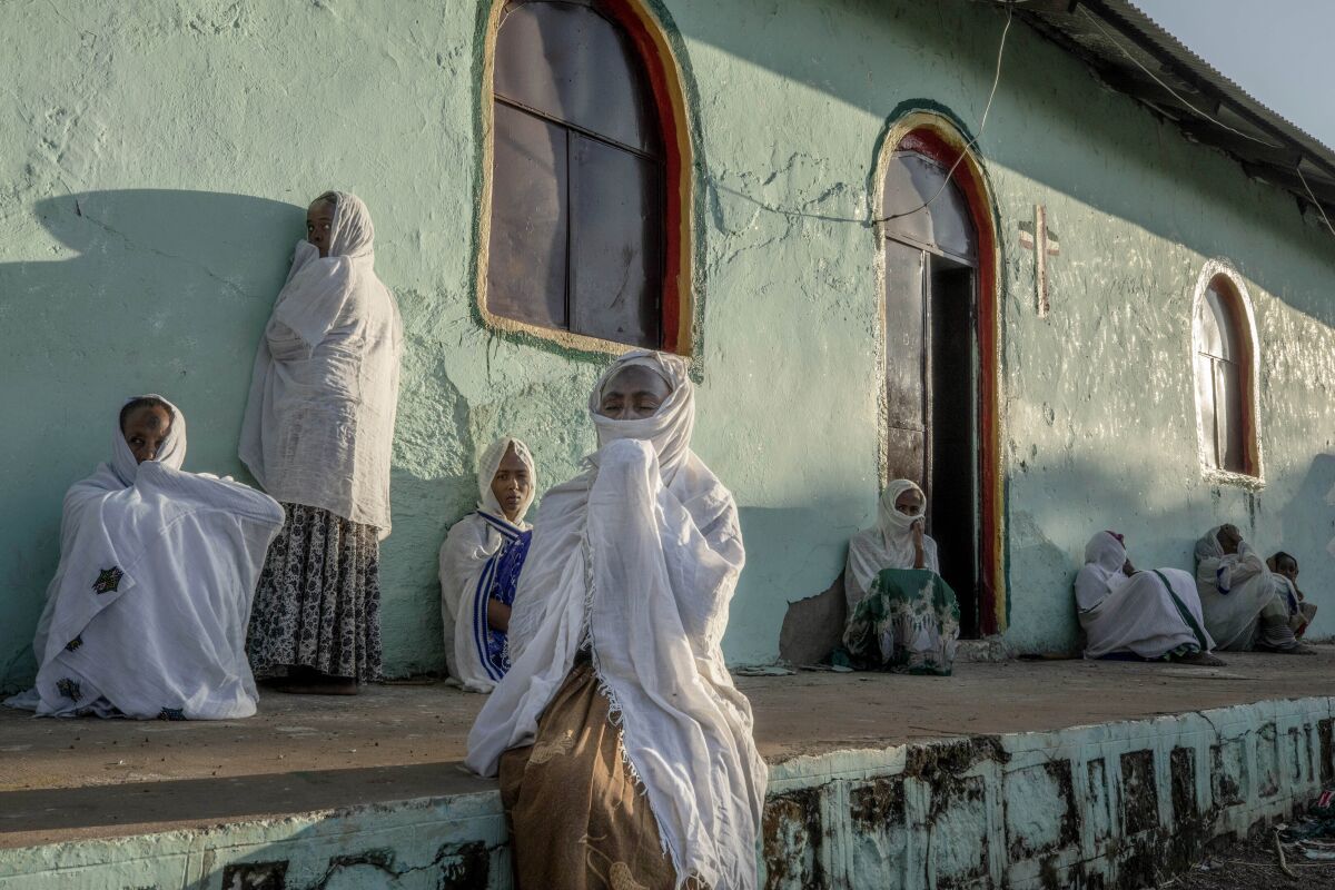 Tigrayan women who fled the conflict in Ethiopia's Tigray region, pray during Sunday Mass at a church, near Umm Rakouba refugee camp in Qadarif, eastern Sudan, Nov. 29, 2020. (AP Photo/Nariman El-Mofty)