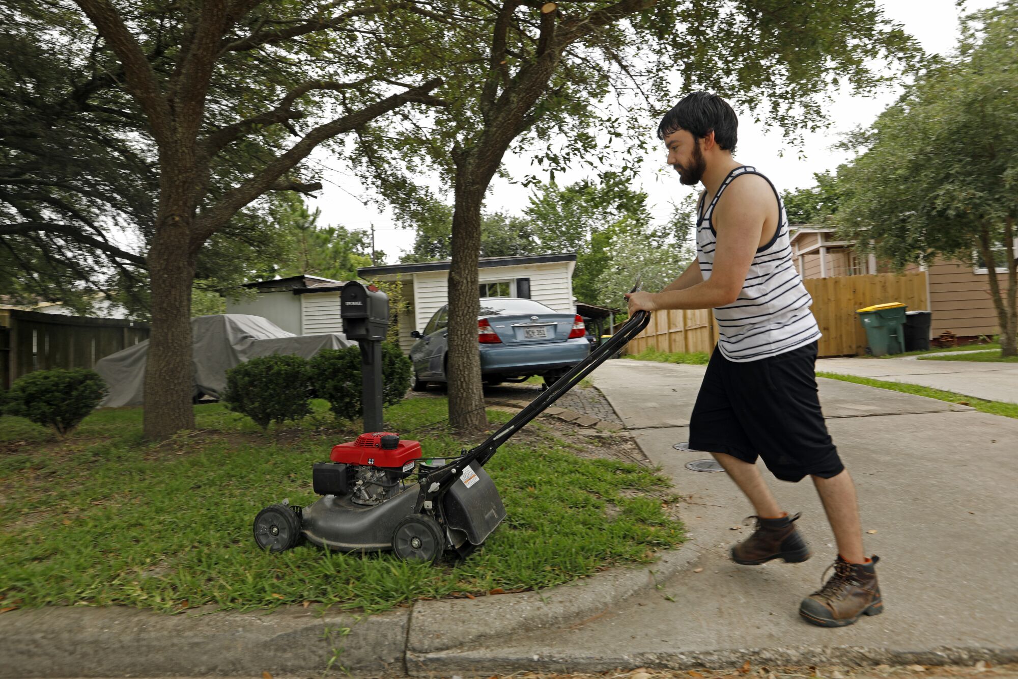 Daniel Herrera, 26, was mowing his own lawn this week after losing contract jobs as an electrician's helper at nearby plants.