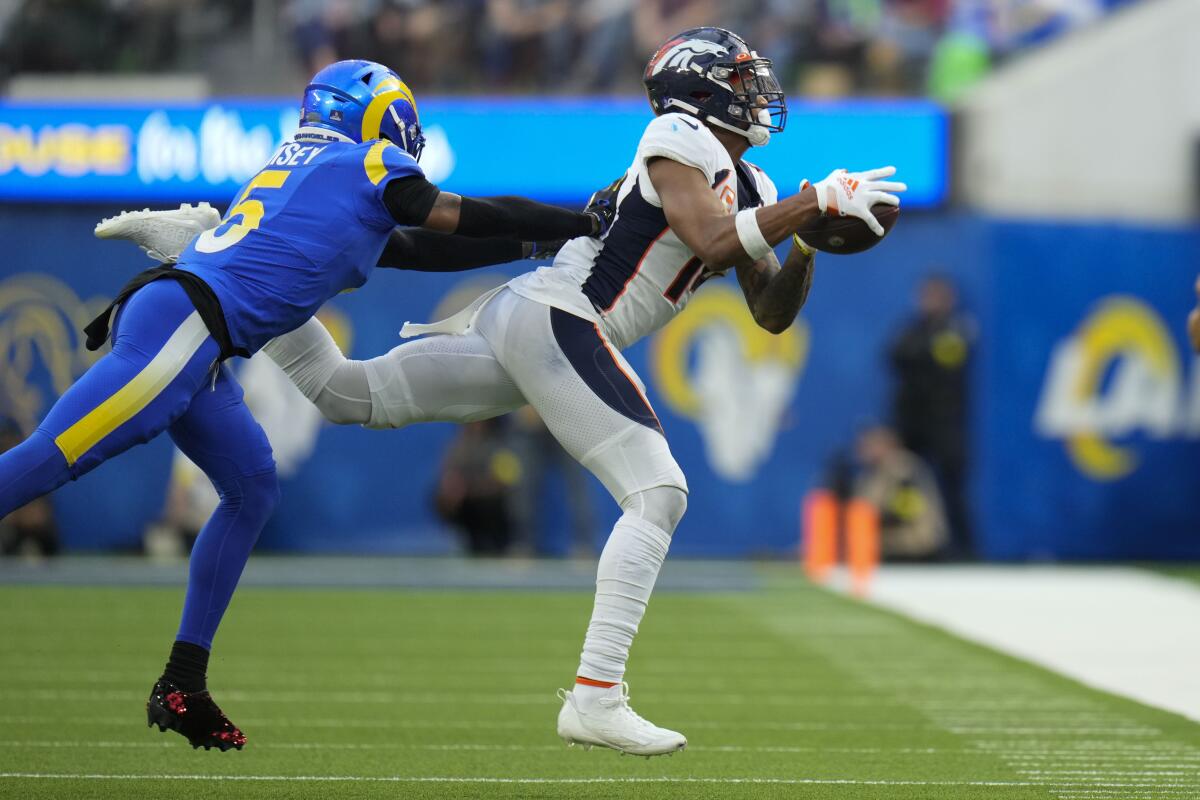 Denver Broncos wide receiver Courtland Sutton catches a pass in front of Rams cornerback Jalen Ramsey during the first half.