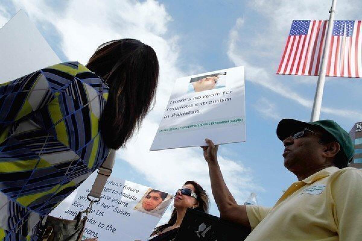 Pakistani Americans join a Los Angeles rally to protest the Taliban shooting of 14-year-old Malala Yousafzai in Pakistan.