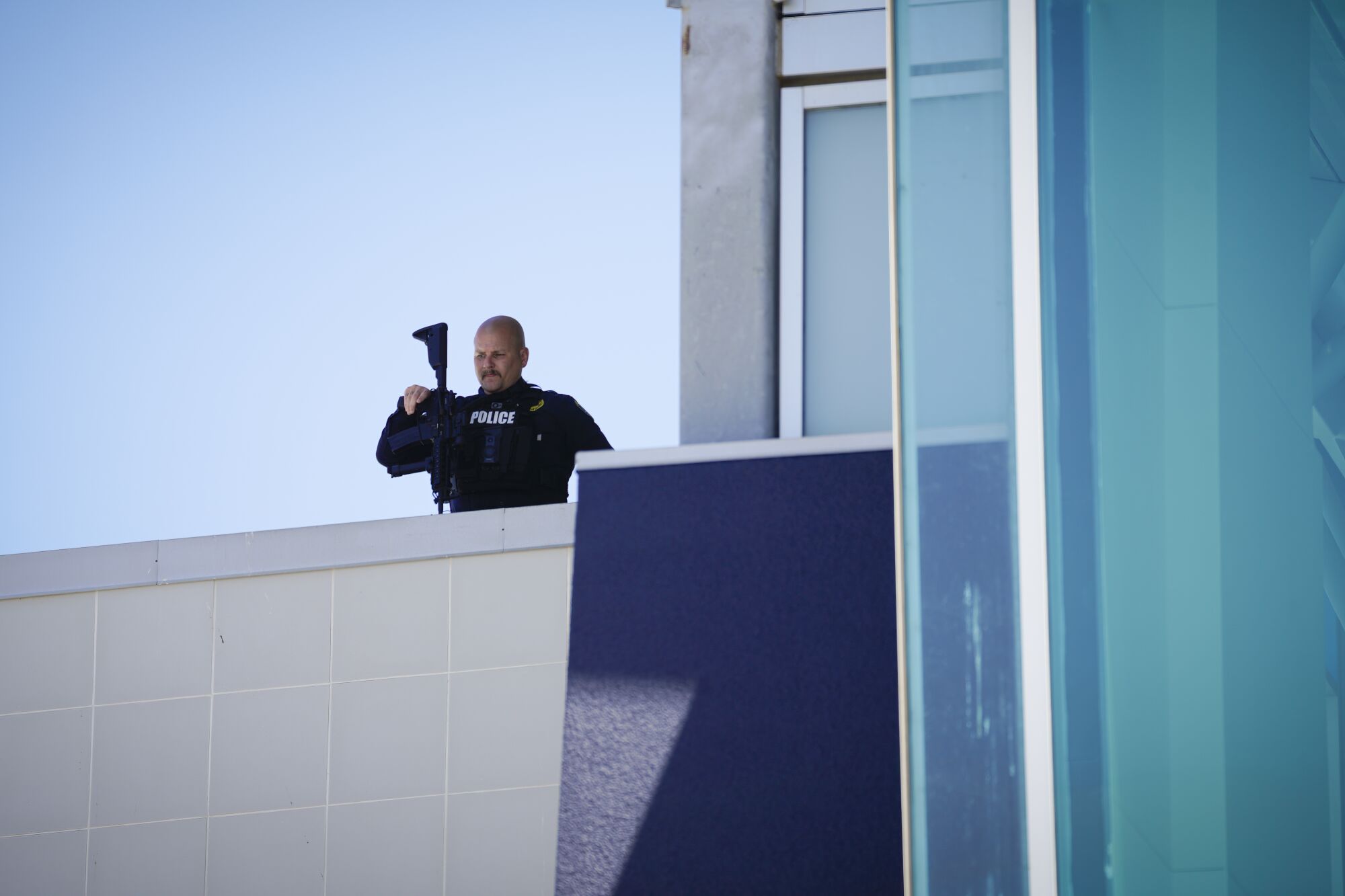 an officer with a rifle remained on the rooftop of the entrance of the school.