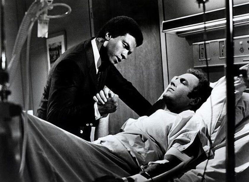 Gale Sayers (played by Billy Dee Williams) comforts Brian Piccolo (James Caan) in a scene from 1971's "Brian's Song."