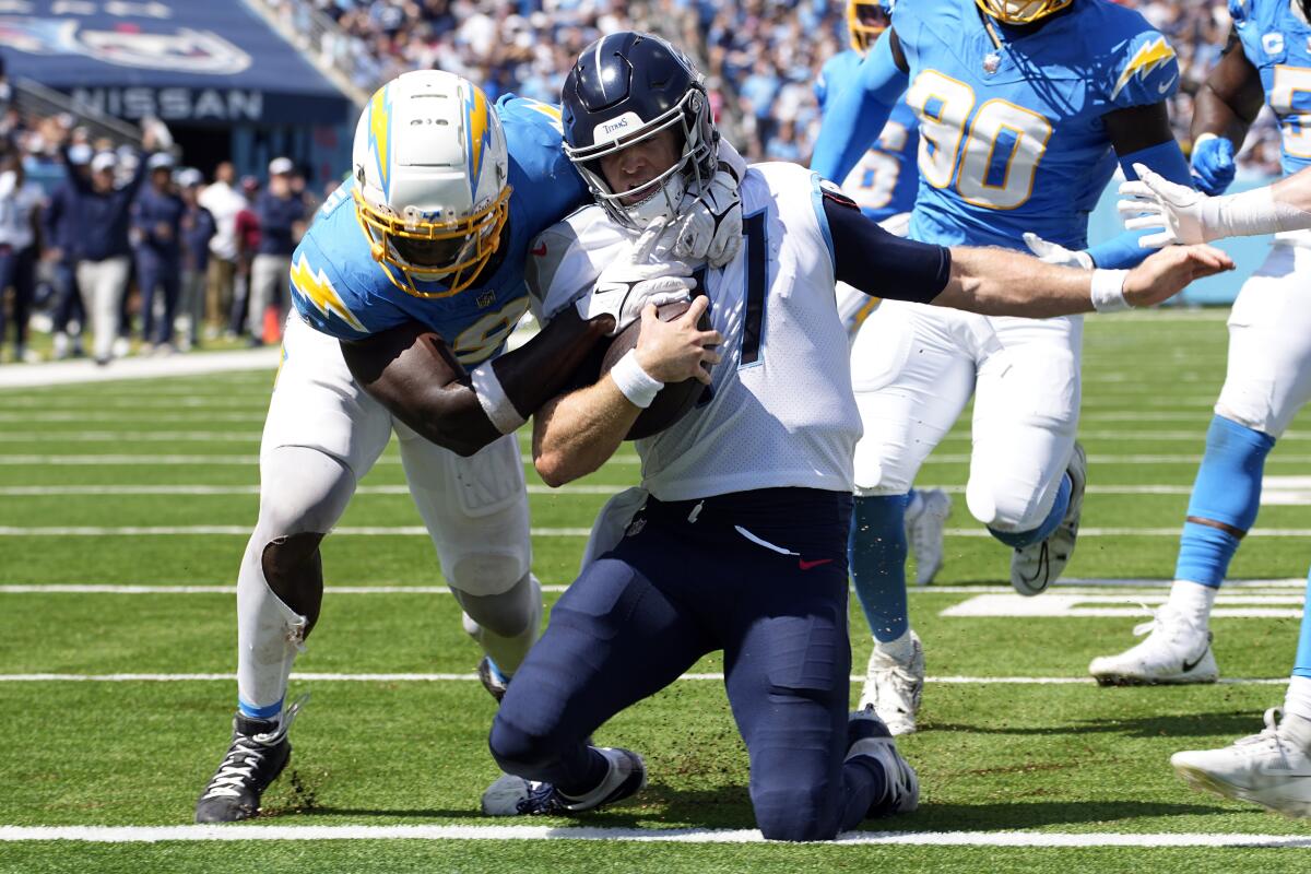 Titans quarterback Ryan Tannehill (17) scores a touchdown before the Chargers' Kenneth Murray Jr. can bring him down.