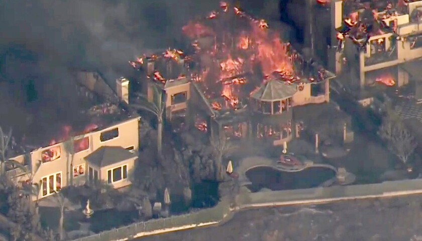 An aerial view of homes on fire