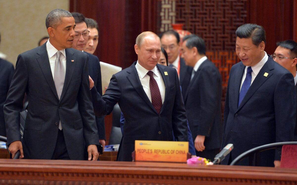 President Obama, Russian President Vladimir Putin and Chinese President Xi Jinping arrive at the Asia-Pacific Economic Cooperation summit's plenary session in Beijing on Tuesday.