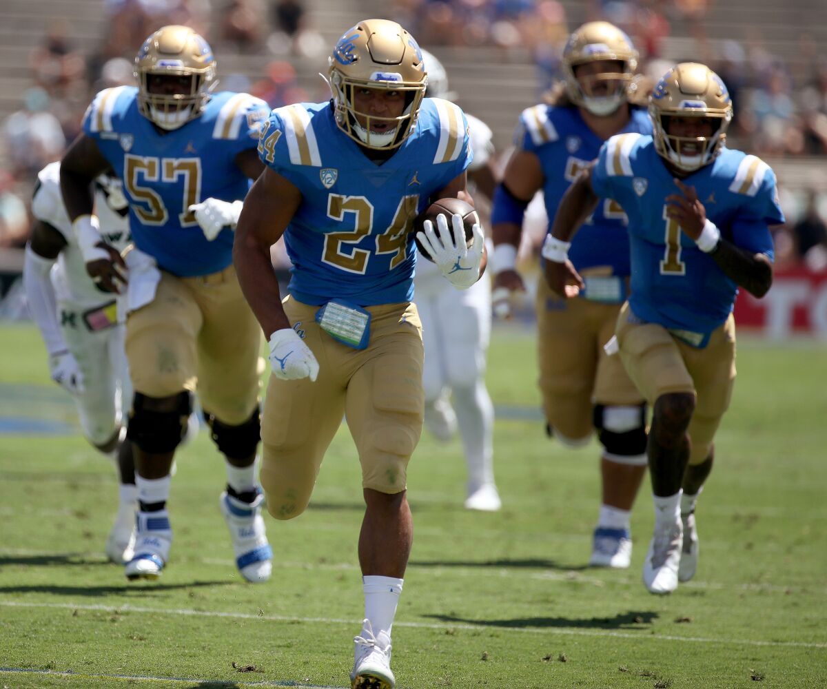 UCLA running back Zach Charbonnet breaks free for a touchdown run against Hawaii in the first quarter Aug. 28, 2021.
