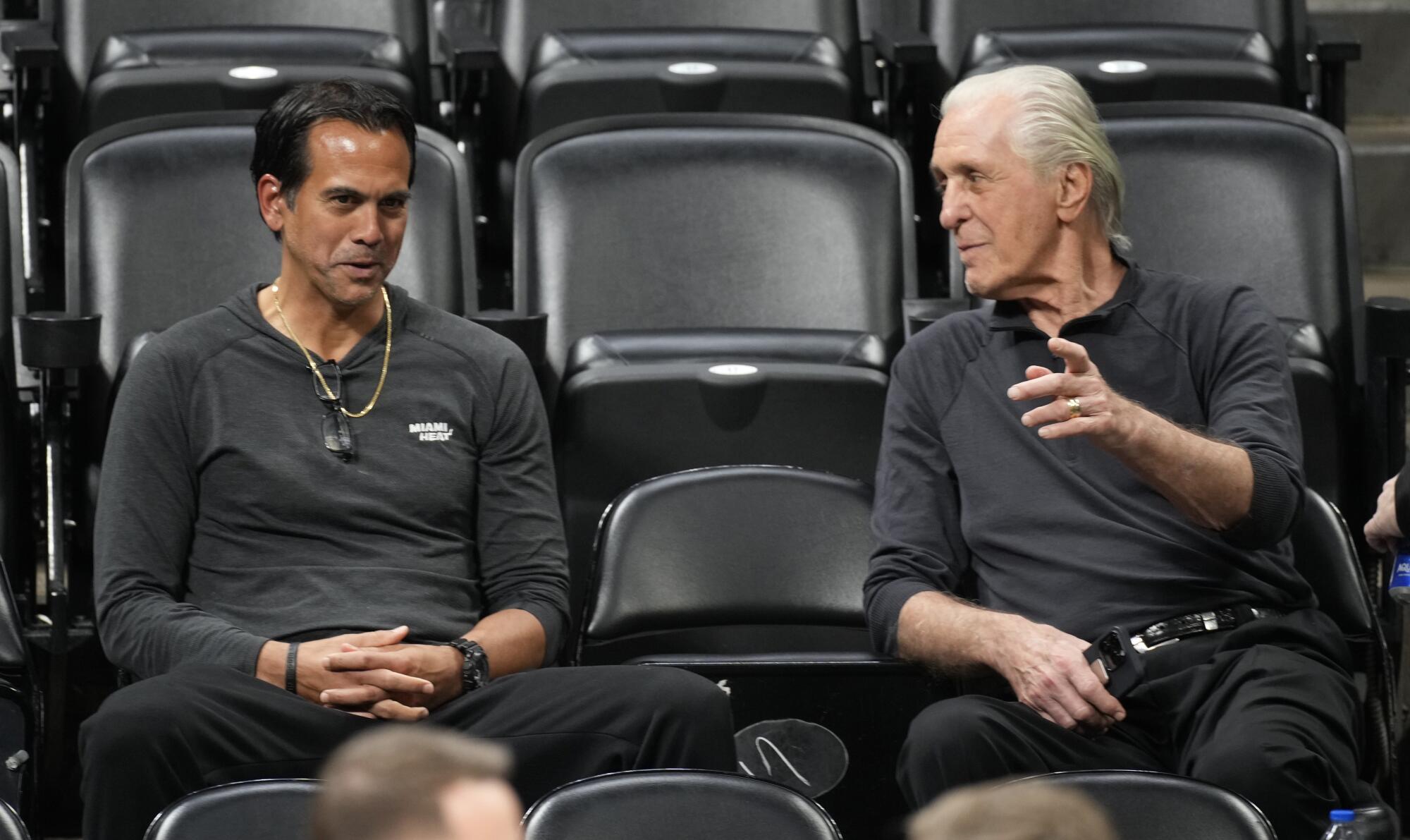 Miami Heat coach Erik Spoelstra chats with team president Pat Riley as they watch players practice Saturday in Denver. 