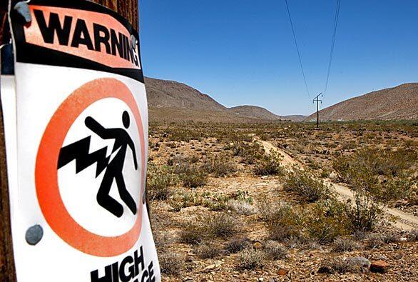 San Diego Gas & Electric and its parent company, Sempra Energy, want to erect industrial towers, some more than 100 feet high, on an easement through Anza-Borrego Desert State Park. Here, smaller poles and wires cut through the Yaqui Well camping and hiking area.