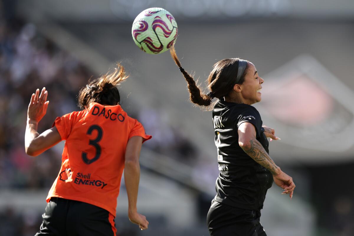 Houston's Caprice Dydasco, left, and LAFC's Sydney Leroux go up for a header.