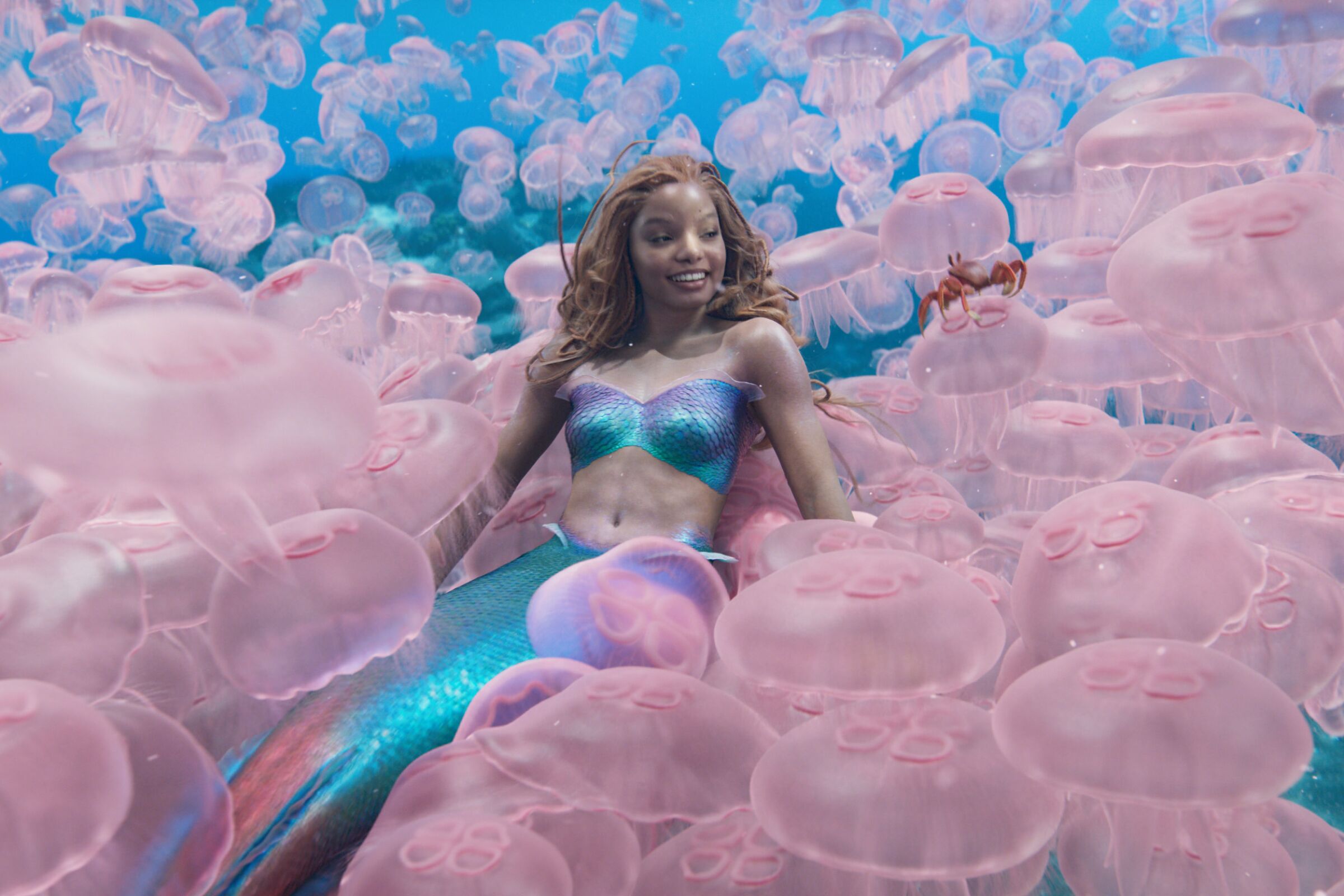 Halle Bailey laying among a sea of jellyfish in "The Little Mermaid."