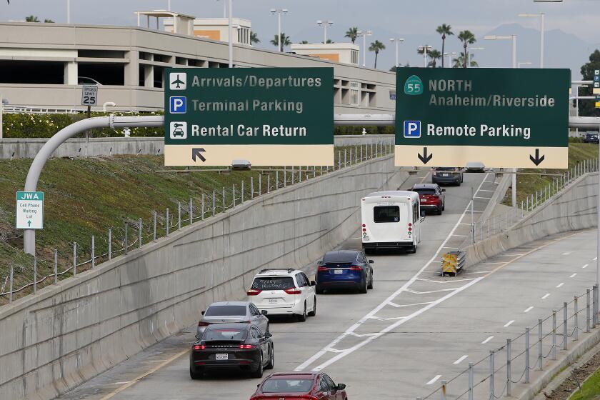 Motorists make their way into John Wayne Airport on Tuesday in Santa Ana. Southwest Airlines has canceled a majority of its flights in and out of John Wayne Airport and travel hubs across the country Monday and Tuesday. (Kevin Chang / Daily Pilot)
