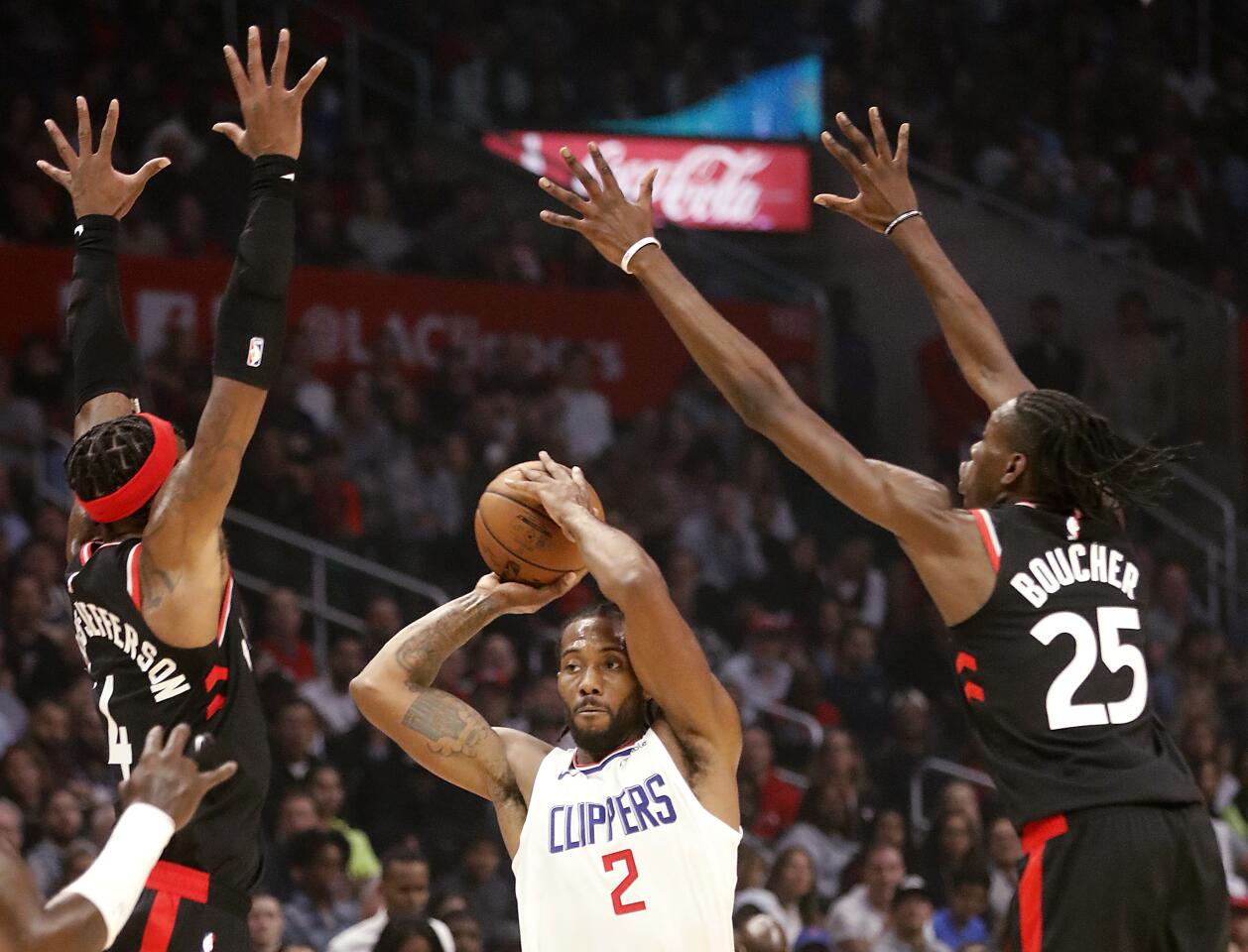 Clippers forward Kawhi Leonard looks for a passing lane against the Raptors during a game Nov. 11 at Staples Center.
