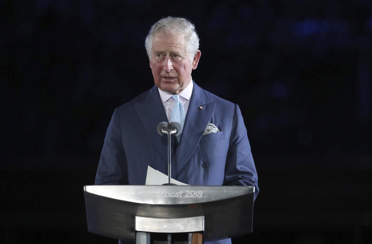 Prince Charles speaks at a dais.