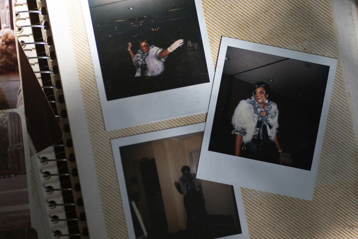 A photo album with old Polaroid pictures of a woman