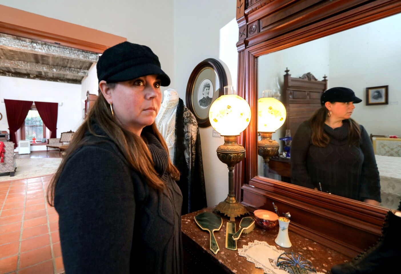 Paranormal researcher Nicole Strickland in the master bedroom of the Rancho Buena Vista Adobe. She's written a book about the hauntings of the historic dwelling.